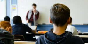 boy in black hoodie sitting on chair